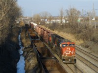 Sunset isn't too far away as a short CN 323 approaches Taschereau Yard with SD75I's CN 5667 & CN 5707 for power as it returns from Vermont. At left is a string of stored gondolas.