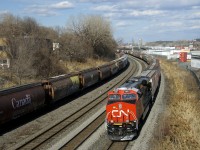 Shiney CN 3887 brings up the rear of grain train CN 874, which is leaving Turcot Ouest after changing crews there. At left grain cars are stored on the transfer track.