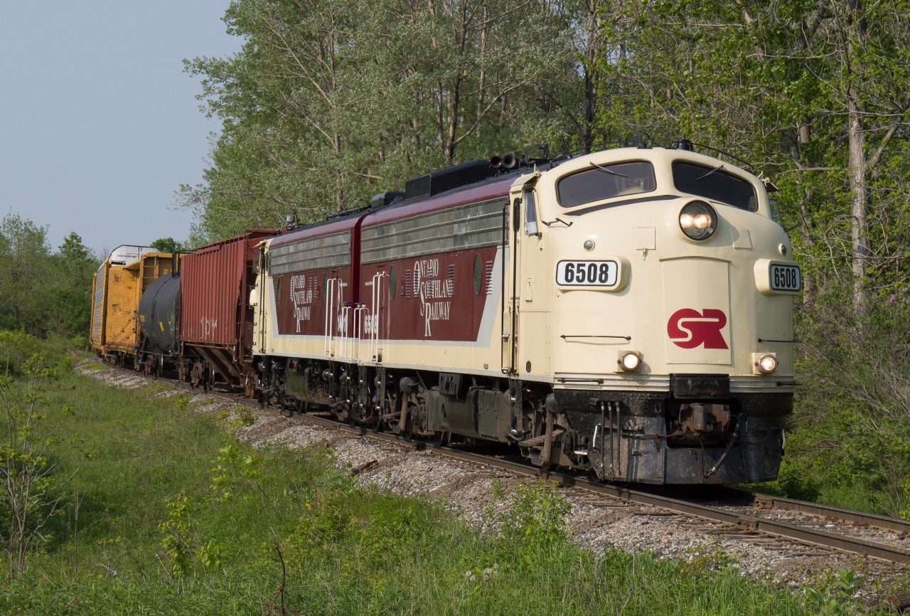 The OSR Woodstock Job approaches Domtar Line outisde of Beachville on a sunny May evening.  Last year I found myself working at a school in Woodstock which provided me with close proximity to the CN Dundas Subdivision, CP Galt Subdivision and CP St Thomas Subdivision.  It wasn't often that the OSR Woodstock Job would still be in Woodstock when I finished work but on this particular day I believe they had to wait on cars from CP which put them later out of Woodstock.  On such a lovely May Friday night I was in no rush to get home so a chase followed.  Domtar Line provides a nice curve for the trip back to Salford and is a favourite of mine.