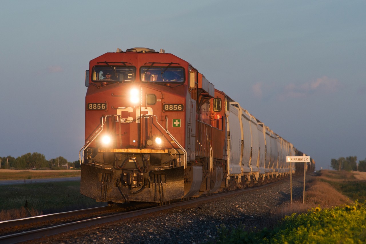 CP 8856 North is just railway north of the town of Drinkwater Saskatchewan at dusk. Although the town's name may lead one to believe it was earned due to available resources in the area, in fact the town was named after Charles Drinkwater, a Secretary-Treasurer during the railway's infant years.