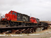 The CN yard job with GP9RM's 7061- 7077 return from CP with a string of covered gondola's backs past the "Western Headworks Canal Parkway" (the walking trail in the foreground), bound for Sarcee Yard.<br><br><i>Note: I have this spur to CP noted as the CN 'GTP Industrial Branch', but feel like the CN line overtop of CP at Ogden is the GTP. Clarification is welcome.</i> 