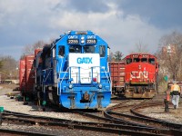 The sun made a brief appearance between April snow squalls as 580 switches out their cars for the day using the smoky GMTX 2255 and GMTX 2695.  After switching for a while they tied up in the yard and conductor and brakeman headed to the office, I can only assume a maintainer got track time so 580 had nowhere to go.  They seemed annoyed as they walked away from their train.  The power at right is the units for CN 581, the nocturnal turn to Garnet that interchanges with the Southern Ontario Railway.