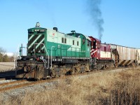 OSR 501 and 502 smoke it up as they shove a cut of racks up the hill to Cami.  The racks are behind three hoppers, I promise you.  The two S-13s were sold to the Waterloo Central a few years ago; I don't believe anyone has posted shots of them at their new home.  Got any?  I encourage you to post them.  I have fond memories of watching a guy paint 501 with a roller while it was parked at CP's Quebec Street yard in London.  He did a good job, the paint held up well!