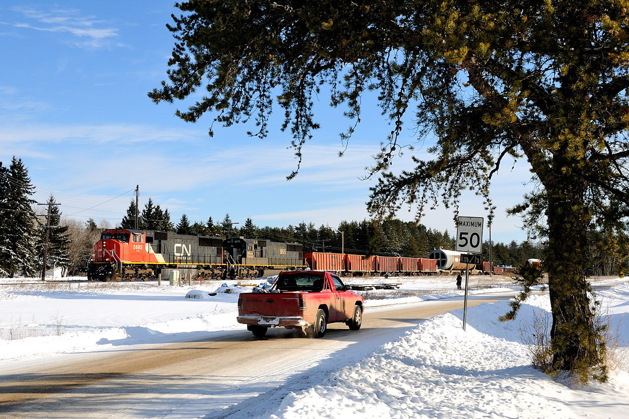 After capturing this movement almost a week prior being assembled in Port Arthur (Thunder Bay North) and being transferred across town to Neebing Yard with far more horsepower than this, CN L351 breaks the silence of small town northwestern  Ontario. SD75i 5685 and IC SD70 1035 have their train, of what I can only describe as "tubes"; 5 in total separated by 5 "spacers" of either gondola's or ballast cars to aid in distributing the weight of the heavy dimensional loads on the rail.