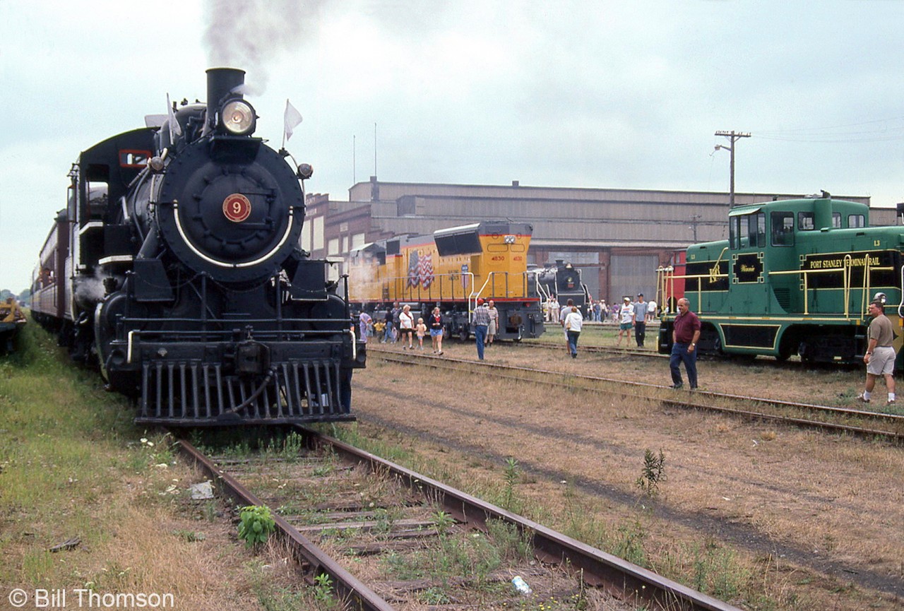 Pictured here is the scene outside the Elgin County Railway Museum in St. Thomas during Iron Horse Days. Among the equipment on display is Essex Terminal Railway 9 (hauling a short consist giving rides to patrons),  CN Northern 5700, Port Stanley Terminal Rail center-cab switcher L3, and brand new Union Pacific SD70M 4830, just built at the nearby GMD London plant. Reading 4-8-4 2100 was also out on display. The old Michigan Central RR shop building (ECRM's headquarters) is visible in the background.