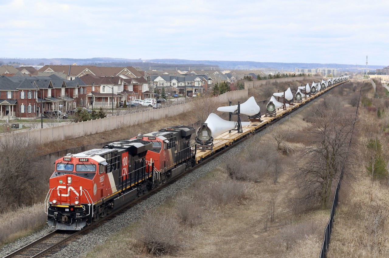CN train 319 with a solid train of wind turbine blades is back up to track speed as it nears Ash in Milton's south end after a meet with train 148 at Milbase.