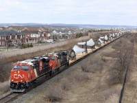  CN train 319 with a solid train of wind turbine blades is back up to track speed as it nears Ash in Milton's south end after a meet with train 148 at Milbase.