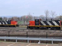 A pair of GMD1's meet at Stuart. CN 7046 - CN 1408 were busy shuffling cars around the yard in a light rainfall. The 1600 job awaits the call to duty with CN 1439, CN 7058, and CN 9416.

