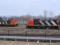 A pair of GMD1's meet at Stuart. CN 7046 - CN 1408 were busy shuffling cars around the yard in a light rainfall. The 1600 job awaits the call to duty with CN 1439, CN 7058, and CN 9416.

