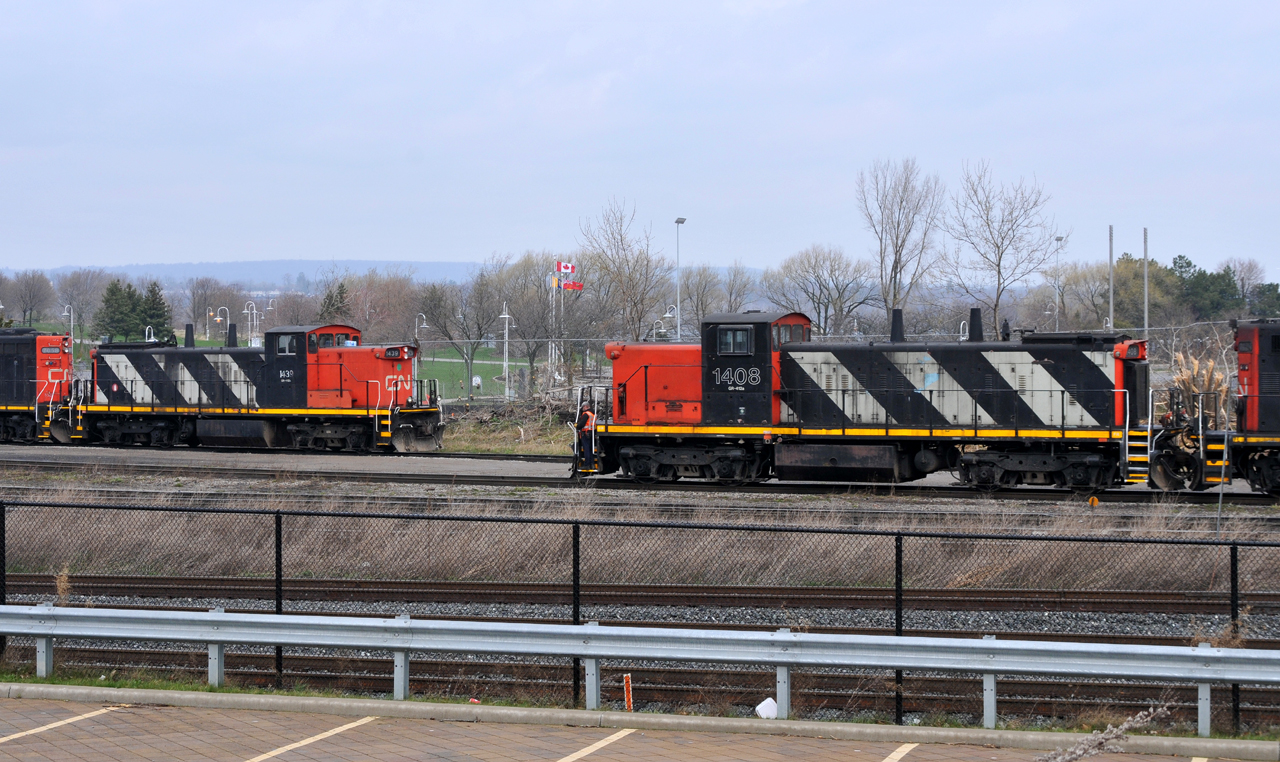 A pair of GMD1's meet at Stuart. CN 7046 - CN 1408 were busy shuffling cars around the yard in a light rainfall. The 1600 job awaits the call to duty with CN 1439, CN 7058, and CN 9416.