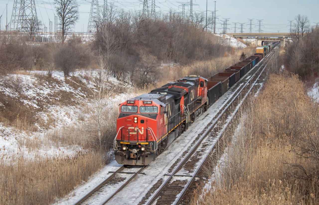 Here we have CN L570 passing under Weston Road in Vaughan, Ontario with CN 2166 leading, a Dash 8M. This unit originally belonged to Union Pacific but was then purchased by Canadian National. CN has recently put a list of units for sale. Most of the units are CN Cowl fleet and a few are the 8M's. They will most likely be scraped as most of them are old and worn down. If you ever find yourself in this area I would strongly suggest stopping by and taking some shots from here as it is a very nice overhead location. To the East you have Mac Yard and to the West you Have BIT (Brampton Intermodal Terminal). You tend to see a fair amount of trains here, Trains consists of Power move from BIT to Mac, Local Job's switching out the industries and the massive manifests for and from the CN Halton Subdivision. Hope you guys enjoy!