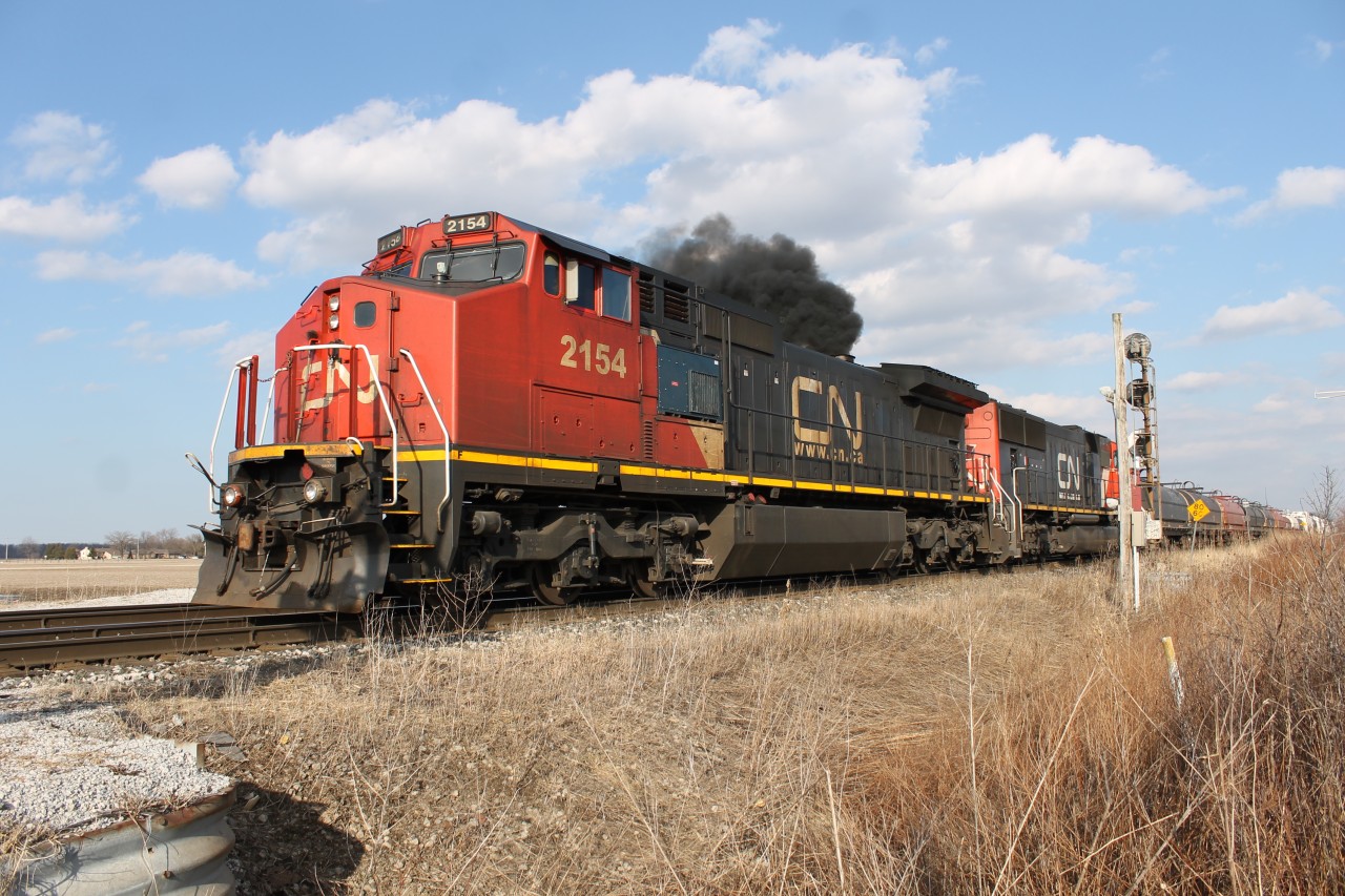 After CN M398 was done making their lift and backed up into the yard, CN M331 had their light at Blackwell to proceed into the yard with CN 2154 filling the blue skies with black smoke.