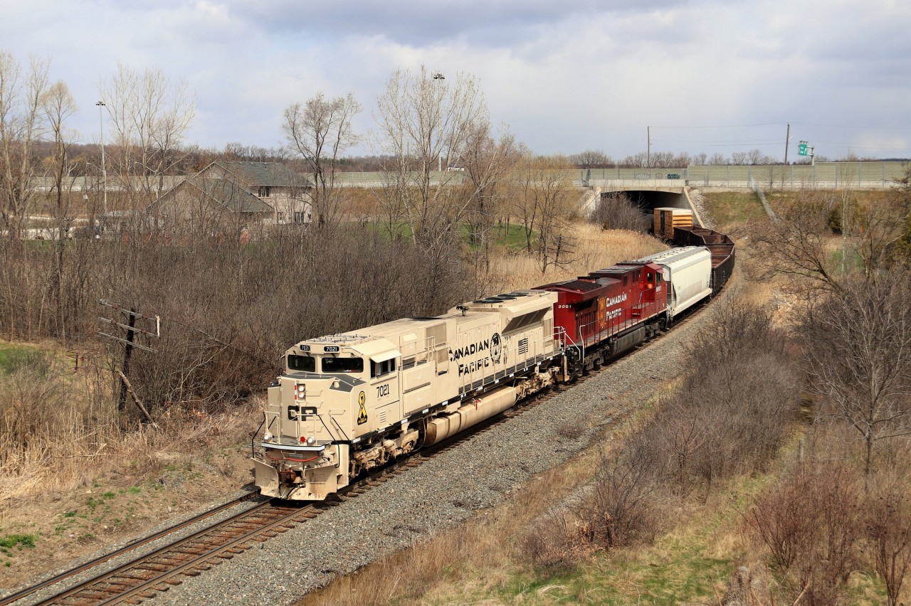 After a tip from a friend about CP 246 having an excellent leader, off I went to start the chase. It started at the Campbellville junction of the Hamilton sub and ended here at Newman Road. CP 7021, all decked out in its sand color scheme to represent the Canadian and US army vehicle paint color, glides out from under the Highway six bridge on its way for a stop at Kinnear Yard. This was a tough chase as the whole train was just over 760 feet long so it maintained good track speed on the way down the hill through Waterdown.