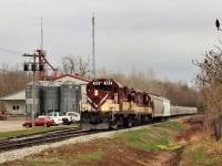 I had went to Guelph Junction to check out what was up and saw the OSR getting ready to depart Guelph Junction so off I went to photograph them on the way to town. Getting them is a tough job in the sun so light rain and overcast skies aided the picture but not me. OSR 181 with OSR 1620 rumble along the bolted rail entering the village of Moffat as they pass the Sharpe feed store. 