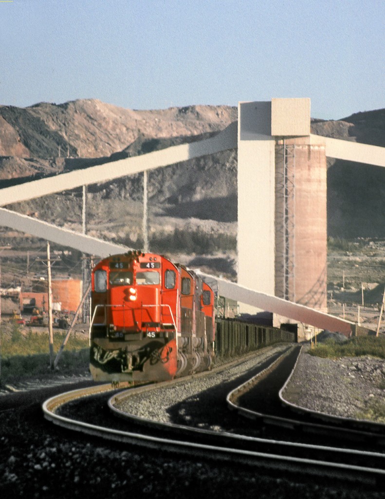 M636 45 leads empty ore train through the loading silos at Cartier Mining's Mont Wright mine at the north end of the railway