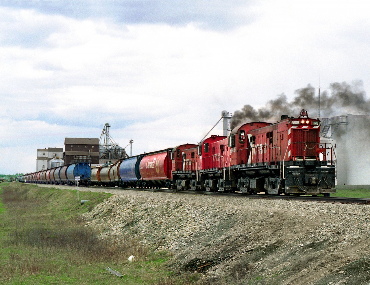 The White Fox Subdivision wayfreight from Prince Albert with 3 RS23's drops its train of grain loads at the south end of Nipawin yard before picking up empties to spot on return trip. The loads will eventually move south via Sheho and connection with the CP's north main. This was done rather than moving traffic via Prince Albert to avoid per axle running right charges on CN