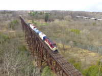 With the possible abandonment, CN's Cayuga sub has gotten a bunch of fame over the past 2 weeks. Operated by OSR once a week, railfans flocked from all over Southwestern Ontario this past thursday to capture what could very well be one of the last trains to traverse the line. With the St. Thomas job being combined with this job that day we were treated to a pair of higher horsepower units, instead of the nose to nose ex. CP pups. Here we see the train crossing Big Otter creek on one of the impressive trestles which are along this line. 