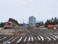 Ontario Southland's St. Thomas job rolls past one of the many farm yards which dot Southwestern Ontario with ex. SOO 383 in lead and 4101 in second. 