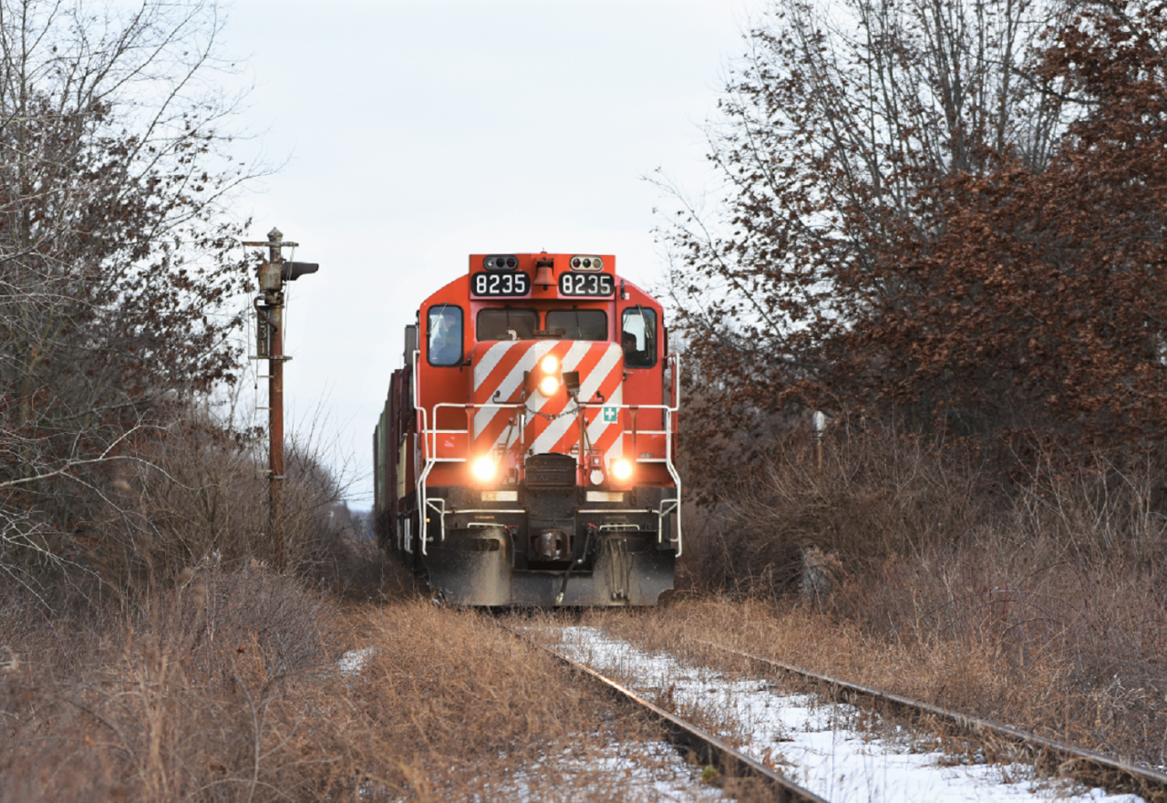 One of the last trains to traverse the Cayuga sub East of Tillsonburg. OSR 8235 and GP9 counterpart 1594 pull a cut of three 3 bay hopper cars past the old CN installed approach signal to the Port Burwell diamond with CP. Today marked likely the final time a revenue freight will traverse the Cayuga sub as OSR is pulling out which in turn will likely force CN to put it up for abandonment.