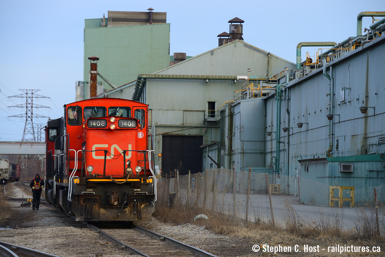 Trains are large - witness the CN employee to left of 1408 as the crew grabs a cut of cars out of the interchange track at Ottawa St in Hamilton. But Steel Plants are larger - Dofasco's aging facility hosts the no1 and no2 galvanizing lines at right amongst other operations. Photographed near dusk on a late March day.
I know these are interesting and difficult times for most - if you do go out please practice appropriate physical distancing and now is not the time to take friends on a road trip. (This is likely Illegal if you are not domiciled with them!). With many people especially our older friends confined to their homes I'd like to think this site is providing a small form of entertainment for many of our fans. Also since our routines have been obliterated and many of us are finding us with more free time, we're happy to see more people scanning and organizing their collections and some even joining us on this site and sharing a few photos. Let us know if you are thinking of sharing but need help - we're here to assist where possible.  Lastly, please stay safe, keep your distance and remember, we'll all get through this together with our health! The chairs are full for the slideshow boys and girls, let's have some fun.

- Steve