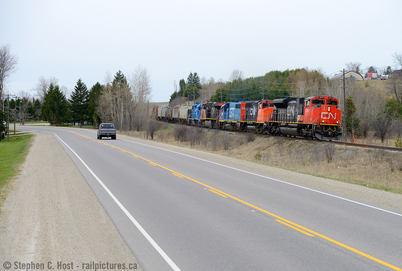This is a shot i'd never try on a regular day as there are far too many vehicles and trucks on HWY 7 - you'll almost certainly get something blocking your shot. This is not regular days and neither is this train -  L533 is leaning into the curve just east of MP45 with a typically large train and an interesting gaggle of motive power variety, but it was the GTW unit in Daylight that got me out of the house. Even still, 533 in Daylight doesn't happen all that often (once or twice a month?). Too bad it wasn't sunny or it would have been even better. In the background is the Jones Baseline overpass.