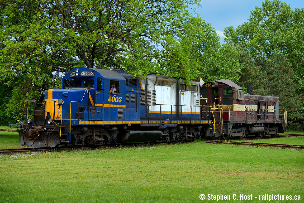 One for the Hamilton and TH&B fans - here we have Cndr. Lance Brown in the cab of RLK 4001 as they have a special, unusual move out of Dofasco's Bayfront facility, a damaged Dofasco locomotive. With the locomotive going to Hamilton's own Railcare for repairs, it did not go far, but I was pleased to be there to capture the moment on camera. Dofasco literally ships nothing by rail directly out of their Hamilton facilities, except the odd Locomotive or bottle car going for repair (every 10 years or so). However, I do believe Dofasco uses the services of the local CN and CP Steel Transfer facilities. The diamond in the foreground allows the bayfront lead to cross the former Coke Oven lead used for NSC storage cars, and Dofasco's plant is well hidden behind all that greenery unfortunately. More to come