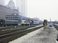 While admittedly not the best image as far as quality goes, I was swayed to post it due to the great discussions arising from a previous 6060 posting.  Other than the Royal York and maybe that CN S13, for a moment Toronto Union looks more like a US terminal. A New York Central sleeper in the business car track and a Southern F7 and N&W unit on a passenger train ?? For the previous week, the NRHS had held its Annual Convention in Toronto and what a time it was. The Southern and N&W units were heading home to Roanoke VA and the NYC sleeper which had arrived on the Southern powered train made its way home on regular trains.
Indeed it was quite a week.    