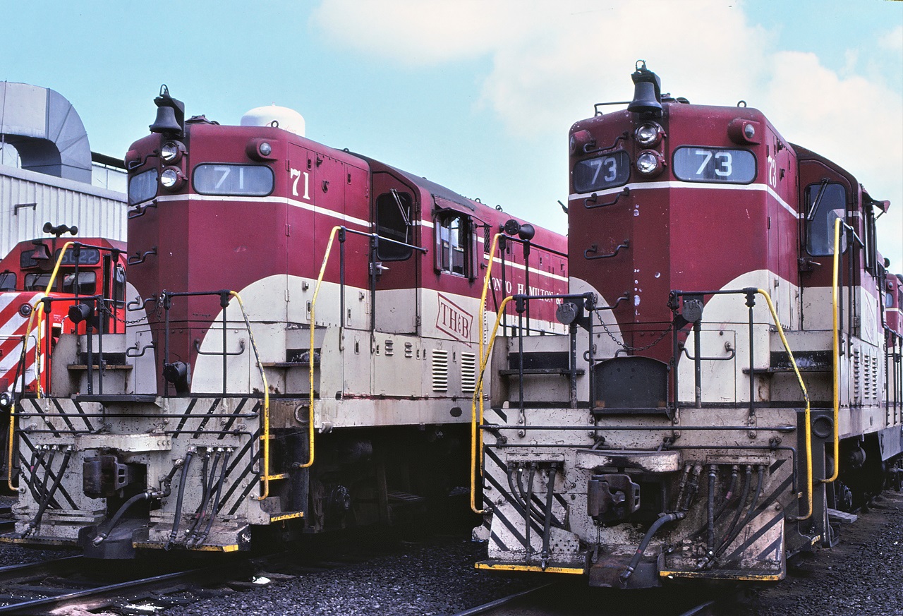 The first and third GP7s built by General Motors in London, Ontario, TH&B 71 and 73 rest side by side at CP's Agincourt Yard on July 29th 1979.  There are several subtle differences between the units, such as MU connection position, battery door louvers, paint differences, and train line/signal line.  The 71 was wrecked less than 18 months later.
