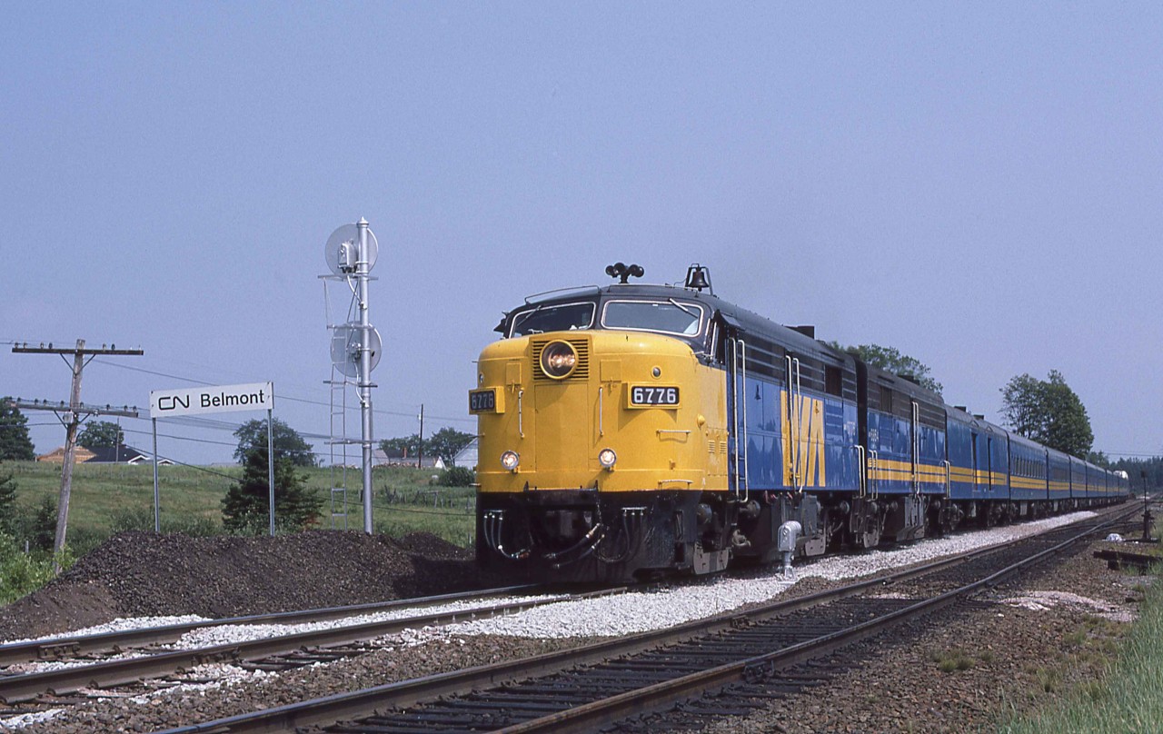 MPA-18a 6776 leads the westbound Halifax - Saint John - Montreal "Atlantic" at Onslow, Nova Scotia, on Wednesday, July 23, 1986.  The "Atlantic" had a checkered history.  Its first incarnation was from October 29, 1979, through November 15, 1981.  It was then replaced on the eastern end by a daily Halifax to Fredericton Railiner. The "Atlantic" returned on June 1, 1985, and ran daily until the Titantic cuts of January 15, 1990.  After that, it began running on a trice-weekly basis departing the end terminals each Monday, Thursday and Saturday.   During this period, the Halifax - Montreal "Ocean" also ran via Campbellton, New Brunswick, with departures each Wednesday, Friday and Sunday.  CP Rail announced its intention to discontinue freight service east of St. Jean, Quebec, at the end of 1994.  The service interruption ultimately lasted only a few days. Nonetheless, the federal government seized the opportunity to terminate the "Atlantic" and shift the trains to the route of the "Ocean" effective December 15, 1994.

CN provided most of the consist of the train included units 6776 and 6864, baggage 9667, coaches 5442 5569 and 5590, coach cafe lounge 2514, daynighter 5746, 6-6-4 sleepers GREENWAY and GREENING, ex Milwaukee Road 10-6 [Lake Keechelus PS-1948] WARPATH RIVER, diner 1358 and ex CP EVANGELINE PARK. 

The "Atlantic" paused at Belmont to meet its eastbound counterpart, Train 12, at 2.30 p.m.  Belmont at Mileage 7.6 of the Truro - Moncton Springhill Subdivision marked the west end of double track that improved traffic flow at the junction with the CN line to Sydney.  The eastern end of the double track was at Hyde, 2.5 miles towards Halifax on the Bedford Sub.  

FPA-4 6776 (MLW 2-1959 #83154) was one of several specially equipped with FRA glass and other features for operation through Maine on the route of the "Atlantic."  You may see it today at the Grand Canyon National Park depot of the Grand Canyon Railway.