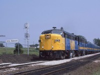 MPA-18a 6776 leads the westbound Halifax - Saint John - Montreal "Atlantic" at Onslow, Nova Scotia, on Wednesday, July 23, 1986.  The "Atlantic" had a checkered history.  Its first incarnation was from October 29, 1979, through November 15, 1981.  It was then replaced on the eastern end by a daily Halifax to Fredericton Railiner. The "Atlantic" returned on June 1, 1985, and ran daily until the Titantic cuts of January 15, 1990.  After that, it began running on a trice-weekly basis departing the end terminals each Monday, Thursday and Saturday.   During this period, the Halifax - Montreal "Ocean" also ran via Campbellton, New Brunswick, with departures each Wednesday, Friday and Sunday.  CP Rail announced its intention to discontinue freight service east of St. Jean, Quebec, at the end of 1994.  The service interruption ultimately lasted only a few days. Nonetheless, the federal government seized the opportunity to terminate the "Atlantic" and shift the trains to the route of the "Ocean" effective December 15, 1994.<br><br>CN provided most of the consist of the train included units 6776 and 6864, baggage 9667, coaches 5442 5569 and 5590, coach cafe lounge 2514, daynighter 5746, 6-6-4 sleepers GREENWAY and GREENING, ex Milwaukee Road 10-6 [Lake Keechelus PS-1948] WARPATH RIVER, diner 1358 and ex CP EVANGELINE PARK.<br><br>The "Atlantic" paused at Belmont to meet its eastbound counterpart, Train 12, at 2.30 p.m.  Belmont at Mileage 7.6 of the Truro - Moncton Springhill Subdivision marked the west end of double track that improved traffic flow at the junction with the CN line to Sydney.  The eastern end of the double track was at Hyde, 2.5 miles towards Halifax on the Bedford Sub.<br><br>FPA-4 6776 (MLW 2-1959 #83154) was one of several specially equipped with FRA glass and other features for operation through Maine on the route of the "Atlantic."  You may see it today at the Grand Canyon National Park depot of the Grand Canyon Railway.