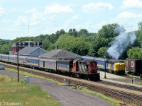 An afternoon down at VIA's Brockville Station finds CN RS18 3125 and a VIA 6600-series B-unit handling train #54 for Montreal, while 6793 sits on the station pocket track in charge of #44's consist for Ottawa. Both ran from Toronto as a combined eastbound #44-54 consist until arriving at Brockville, where the consist would be split, a spare unit at the station would couple to #44's cars, and each separate train would then continue on to its respective destination.<br><br>After the 1981 cuts to VIA, equipment from The Canadian ran between Toronto and Montreal on corridor trains #53 and #54, hence the stainless steel ex-CP Budd cars from The Canadian shown in today's consist of VIA #54 running through (there's more information on this arrangement on <a href=http://tracksidetreasure.blogspot.com/2016/08/via-builds-and-splits-trains-at_17.html><b>Trackside Treasures</b></a>).