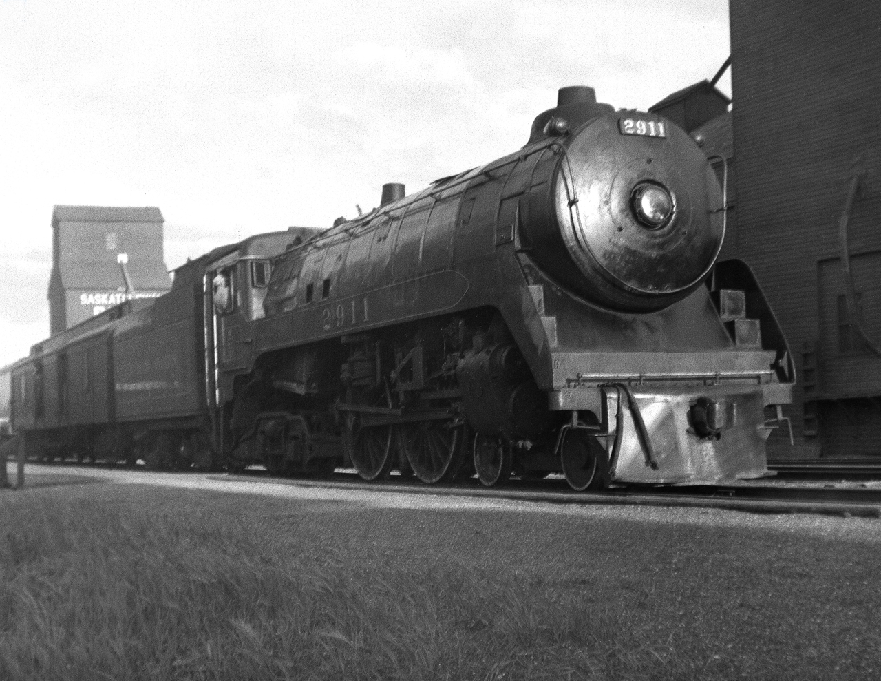 The Brandon to Regina local passenger train with F1a 4-4-4 2911 on the point works the station while the engineer looks back for the signal to depart. F1a's unlike the high speed streamlined F2's were used on local passengers on the prairie region along with G5 4-6-2's