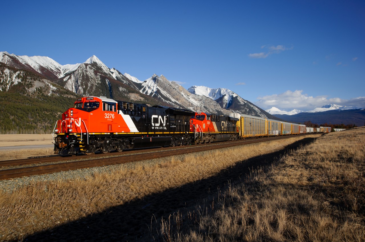 Brand new CN ET44AC 3276 returns east from Vancouver after making its maiden run west a couple of days ago. It's seen here at Henry House bringing Vancouver-Chicago train M356 to a stop to meet a couple of westbound trains. The new white roof on these units goes nicely with the white peaks of the mountains.