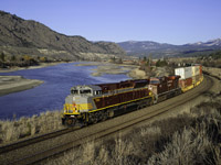 CP SD70ACU 7018 speeds towards a crew change at Kamloops, following the shores of the South Thompson River with 101-07's train between Ducks and Bromley on the north track of CP's scenic Shuswap Sub.