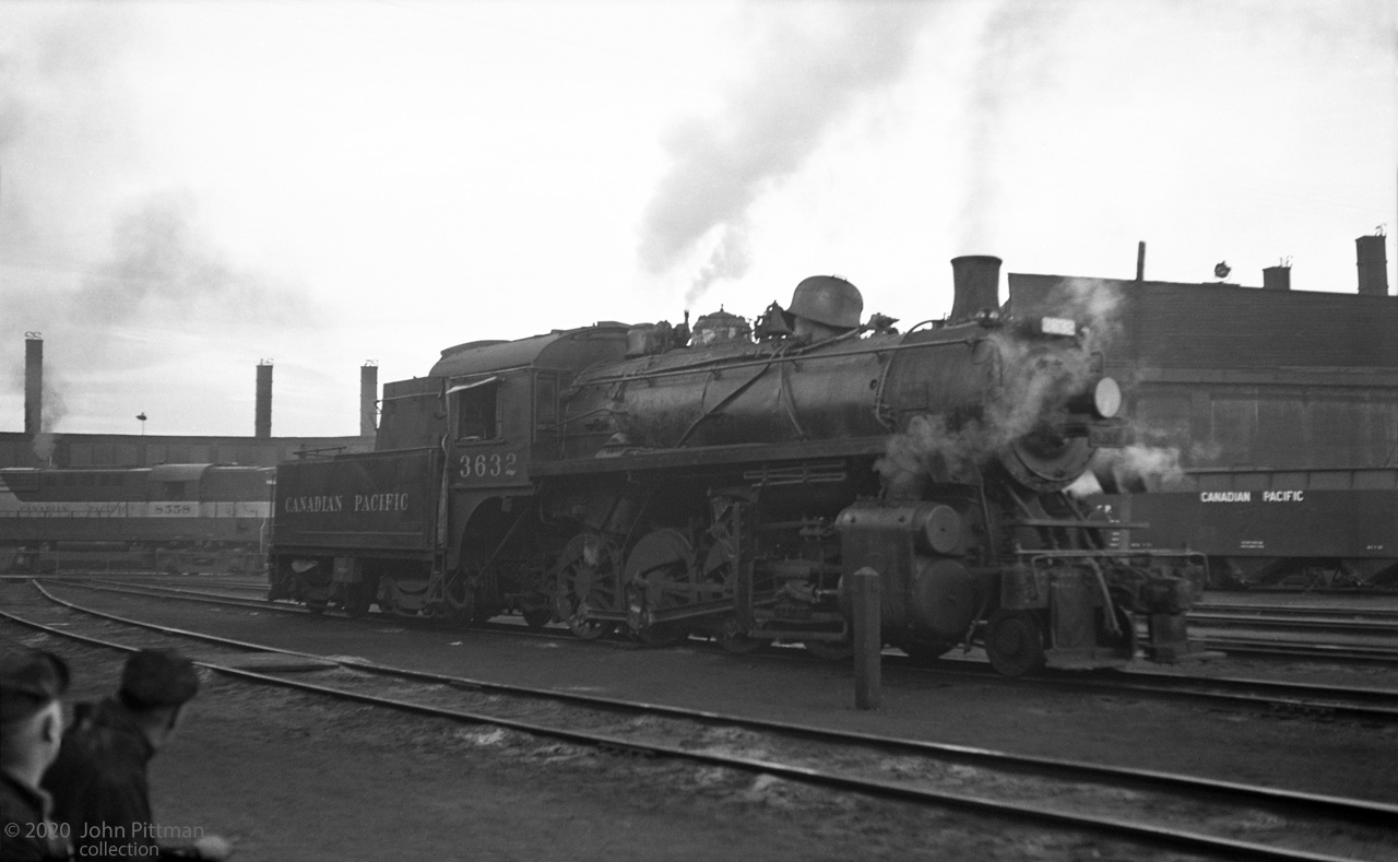 CP 3632, a class N2A 2-8-0 built by CLC in 1911, was one of CP's last steam engines in regular service. 
It served at Port McNicoll Ontario in the last month of regular steam operation on the CPR, April 1960.
This image dated May 1960 appears to be outside Lambton roundhouse (with its numbered smoke jacks).
CP 3632 is in steam and getting some attention - note the steam dome cover is off, temporarily placed on the sand dome. The guys at bottom left might be taking a break from this activity.
In the background CP 8558, an RS-10 built by MLW in 1956, is on the roundhouse turntable.
