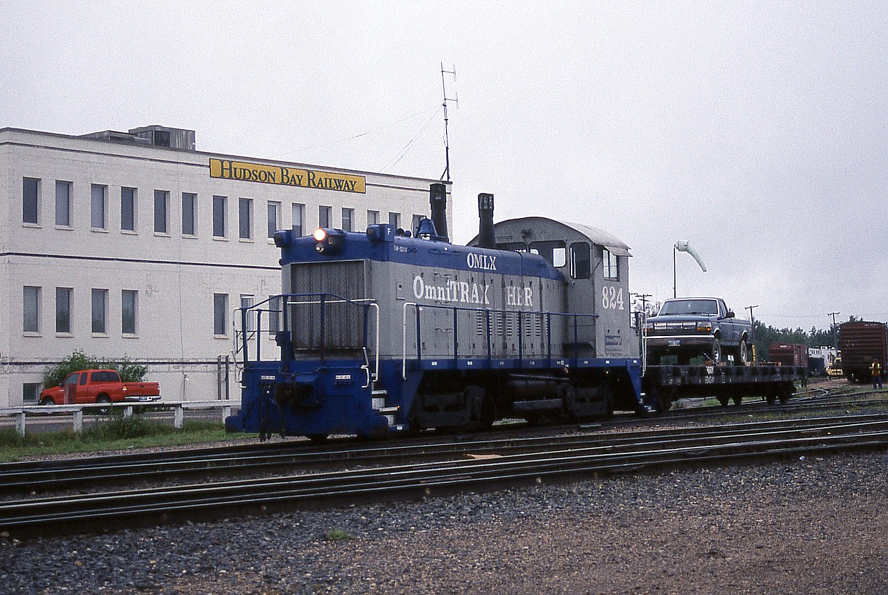 It's early in the morning and the Hudson Bay Railway yard crew in The Pas is already at work getting the freight cars together for the mixed train to Pukatawagan.  Someone's sweet ride is securely chained to an old cut down bulkhead flatcar for the trip north.  Once the freight is together the spare VIA F40PH in The Pas will be used briefly to move some tank cars out of the way.  Then the mixed train power, a pair of M-420(W)s, will bring the assembled freight cars down to the station so they can be combined with the passenger cars and be on their way.  It was fun to watch all the action at the yard and station.  I'll always remember the train goes to Pukatawagan because I recall someone saying don't forget to pack-a-toboggan.