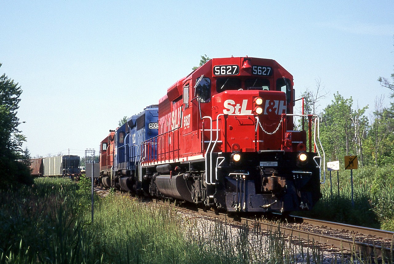 St. Lawrence & Hudson Railway train 270 is at Guelph Jct. swinging off the Galt Sub. and on to the Hamilton Sub. with STLH 5627, HLCX 5036, and CP 5518.  That is if I'm reading my scribbles on the slide mount correctly.  And I thought my printing was messy now.  Yikes.