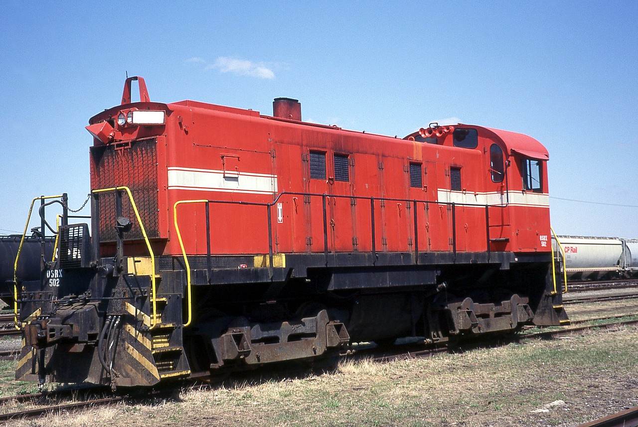 Follow-up to the photo I posted of OSRX 501 and 502, and the photo Jason Noe posted of 501 when it arrived in London in BC Rail paint.  I had assumed 501 was purchased from the BC Rail, however in looking up the history of 502 I found that 501 came from the Greater Winnipeg Water District.  502 didn't come directly from BC Rail either, having spent time at Vancouver Wharves before coming to the OSR.  The photo shows OSRX 502 parked in the yard outside the Elgin County Railway Museum in St. Thomas, ON.  You can faintly see "Vancouver Wharves" is the space between white stripes.  It's interesting how the pair were reunited after being sold off by BC Rail.  They were originally built as Pacific Great Eastern 1001 and 1002 and now are both preserved at the Waterloo Central Railway.  I suppose one may become a parts source but time will tell.