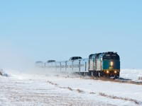 A very late VIA#2 is seen racing through the frozen prairies at Scott Saskatchewan with a short off-season consist. 