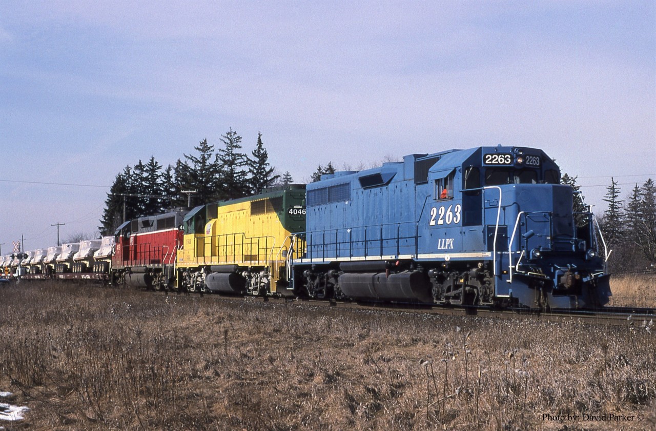 GEXR #432 heads East on the CN Halton Sub crossing Winston Churchill Blvd with a colourful consist leading some flats full of new military vehicles from GMDD London.