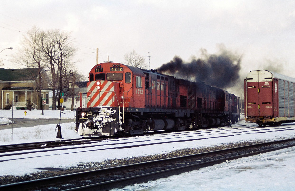 CP's London Pick-Up is putting on a smoke show in front of the Galt station as it heads toward the mainline after going around the wye with C424's 4212, 4216 and RS-18u 1813. At the time, this assignment ran Monday-Saturday from London to Galt to set-off and lift traffic for Toyota as well as service other customers along the mainline as required.