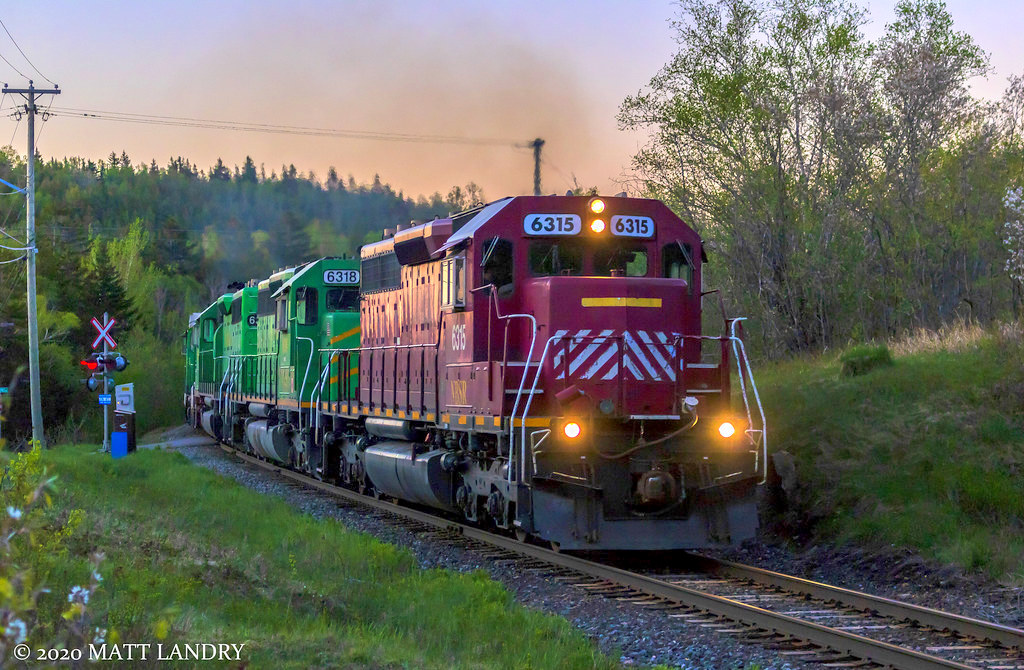 With the sun slowly rising for another day, train 907 is westbound, shortly after departing Saint John, seen here at Ketepec.