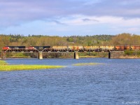 CN 2925 leads potash train B730 across the small trestle at Hammond River, New Brunswick, on a muggy morning. 