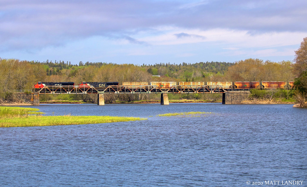CN 2925 leads potash train B730 across the small trestle at Hammond River, New Brunswick, on a muggy morning.