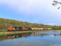 Potash train B730 rumbles by the lake, approaching Saint John, New Brunswick. 