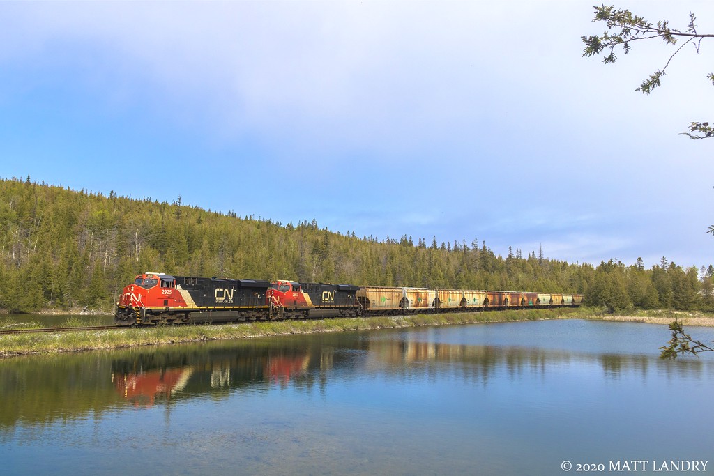 Potash train B730 rumbles by the lake, approaching Saint John, New Brunswick.
