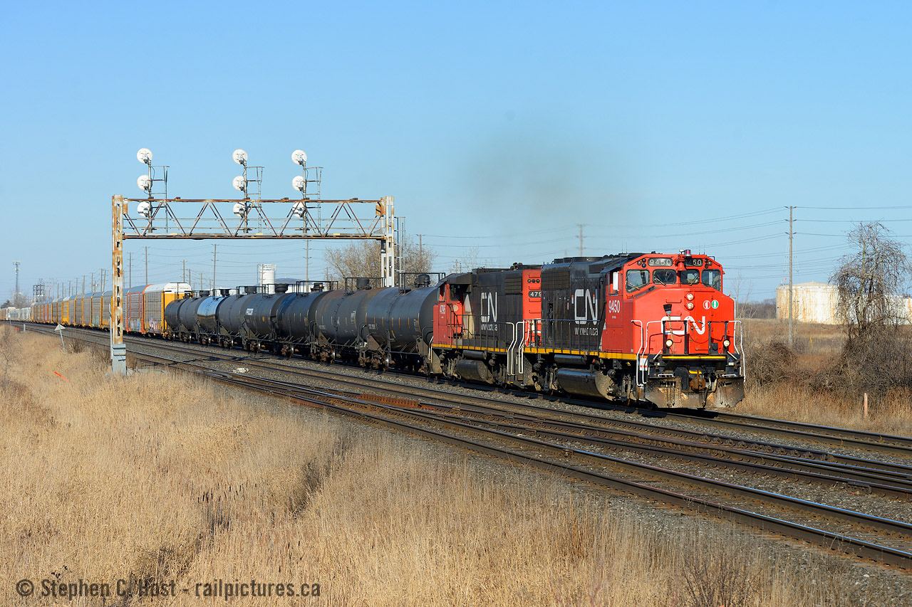I lived near here for a few years in the mid to late 80's, and my Grandparents called it home into the mid 90's so Burlington is a place I've always enjoyed visiting. (Almost moved here a few years ago too!). I played soccer in Sherwood Forest park just to the east of this spot and most certainly was distracted by the trains. Nothing has changed except the road has become much wider (soon to be made into an Underpass) and these classic Searchlight signals of the Oakville are the signals of my youth. With a skating tournament nearby all weekend I took the opportunity to make sure I caught the train while I had the time. This is only my third train photo here over the last 15-20 years. 554 has a good cut of cars, somewhere around 85 cars, cement from CRH Port Credit, lots of autos from Oakville and after working Suncor (former Petro Canada refinery) in background for an hour and a half has a good cut of petroleum too.
Fun fact: In the 80's you could really smell the sulfer from the refinery, some nights it was really strong, seems those days are long gone.