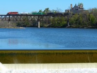 The light blue morning sky is cloudless and the sun is in full force in the city of Cambridge this morning as this years CP weed sprayer train soars over the Grand River with 1983 built SD40-2 numbered 6045 in the lead. At roughly 25mph, the engineer will ease the train spraying chemicals along the ROW towards London with a Track Block west of Woodstock where the train will hold for a time amount I’m unaware of. Good to see spring developing and the grey colours being eliminated with the blooming green trees and the bright sunlight. Temperature was ideal near the water as well, such an amazing morning. 