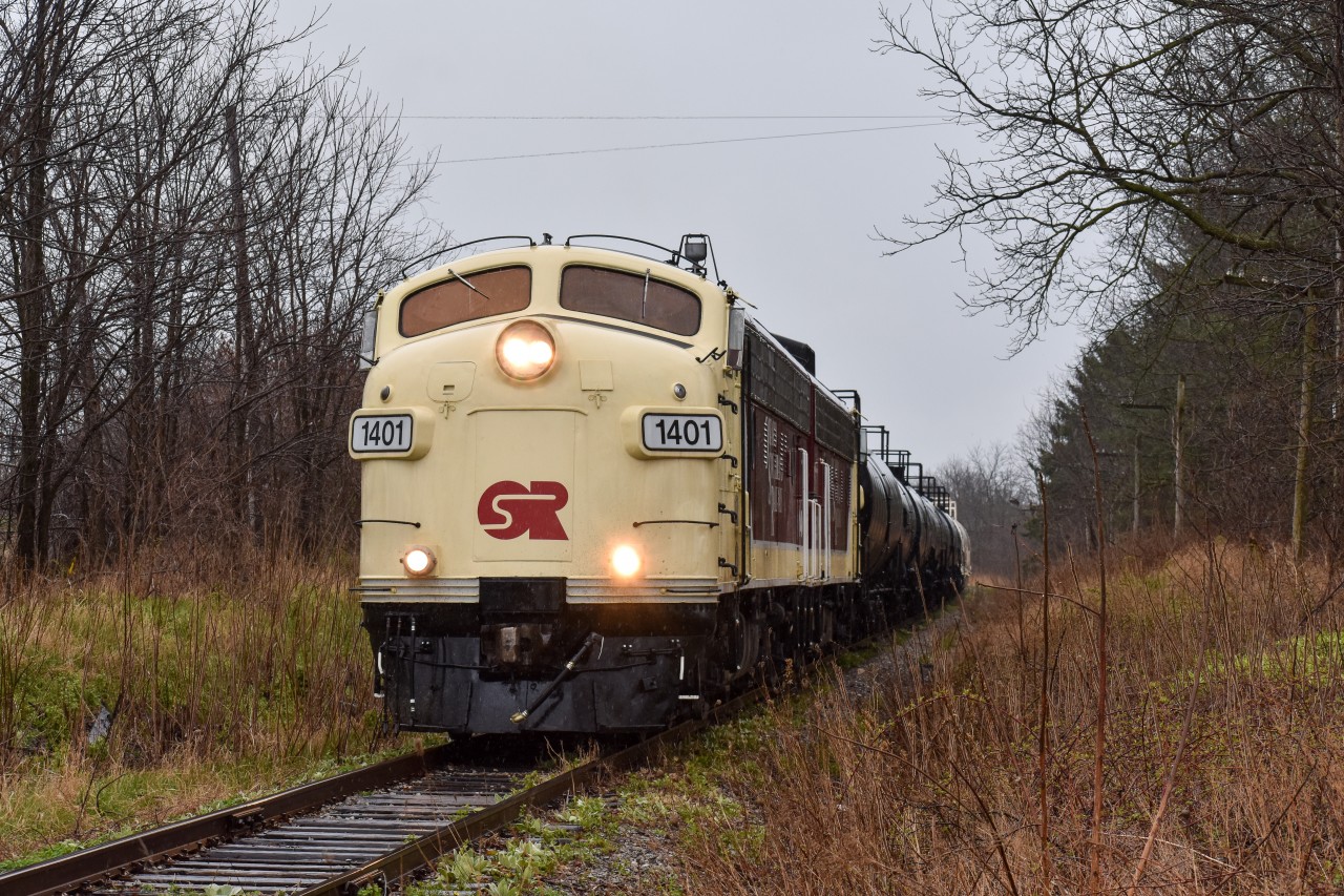 “Last Stand”

OSRX 1401 & 6508 take charge of the final “Cayuga Clipper” through Belmont Road just west of Aylmer, ON. 

Today was definitely a day to go down in history, as the last revenue freight train rode the rails of the “Canada Air Line” from Tilsonburg to St Thomas today. Over the 147 years this line has existed, it has seen its fair share of operators, including CN,CP, TH&B, NW/NS, and many more. Known officially as the CN Cayuga Subdivision until 1995, it linked the once extremely busy St. Thomas (aka Railway City) with Buffalo, NY. After CN abandoned the majority of the line in ‘95, the remaining portion from St. Thomas to just east of Tilsonburg was renamed the Cayuga Spur, and only existed for industries located along the line who still requested rail service. Since then, the line has seen use from Trillium as well as OSR but as far as I know, operations became fewer and further between as customers along the line either started to leave or switch to trucks. Since the line was no longer feasible to the current Operator (OSR) the decision was made to pack it all up, with only one industry remaining on the line. For the past couple weeks, OSR has been picking up cars which have sat in sidings for years, even decades in some cases (see @boxcar_gaynor ‘s profile for pictures of some old CASCO tank cars) and dragged them out in preparation for abandonment. Although nobody knows the actual future for the line, it’s nearly impossible to be optimistic considering the stories for many of Ontario’s rail lines have been all too similar to this one. But regardless of if it is or isn’t the last train to ride these rails, I’m glad to have seen history in the making today. (Please correct me if I made any mistakes in the caption!)
