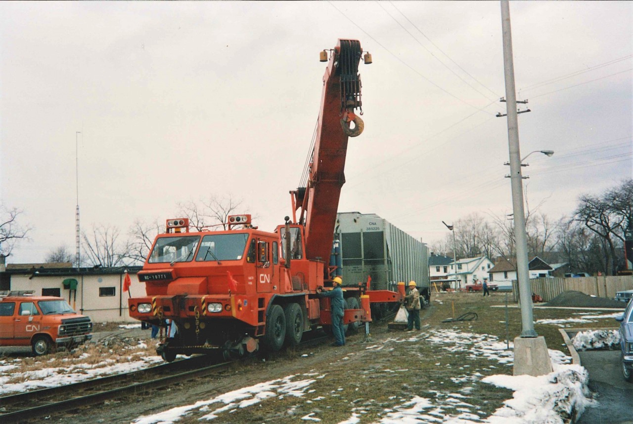Fully loaded covered grain hoppers end up off line as the rails snapped like twigs in multiple locations.  Although difficult to see, there are 5 cars involved.  The (2) GP9RM lead locomotives were moved further south across Clarence Street to keep the crossing open, and GP9RM 4102 (barely visible extreme right) was brought in to clear 2 cars that were blocking the Fielden Ave Crossing. The RC 10771 was a 110 Ton unit and was one of the few such cranes stationed in Ontario.   The semaphore in the background was then permanently yellow and always in the raised position shown. It was likely removed when Bridge 20 was taken down a few years later.   Interestingly enough, Trillium who has operated the lines here since 1997 suffered a near identical 5 car derailment on April 3, 2018, almost exactly 24 years to the day.